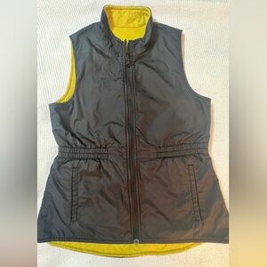 CAbi Quilted Reversible Travel Vest in black and chartreuse